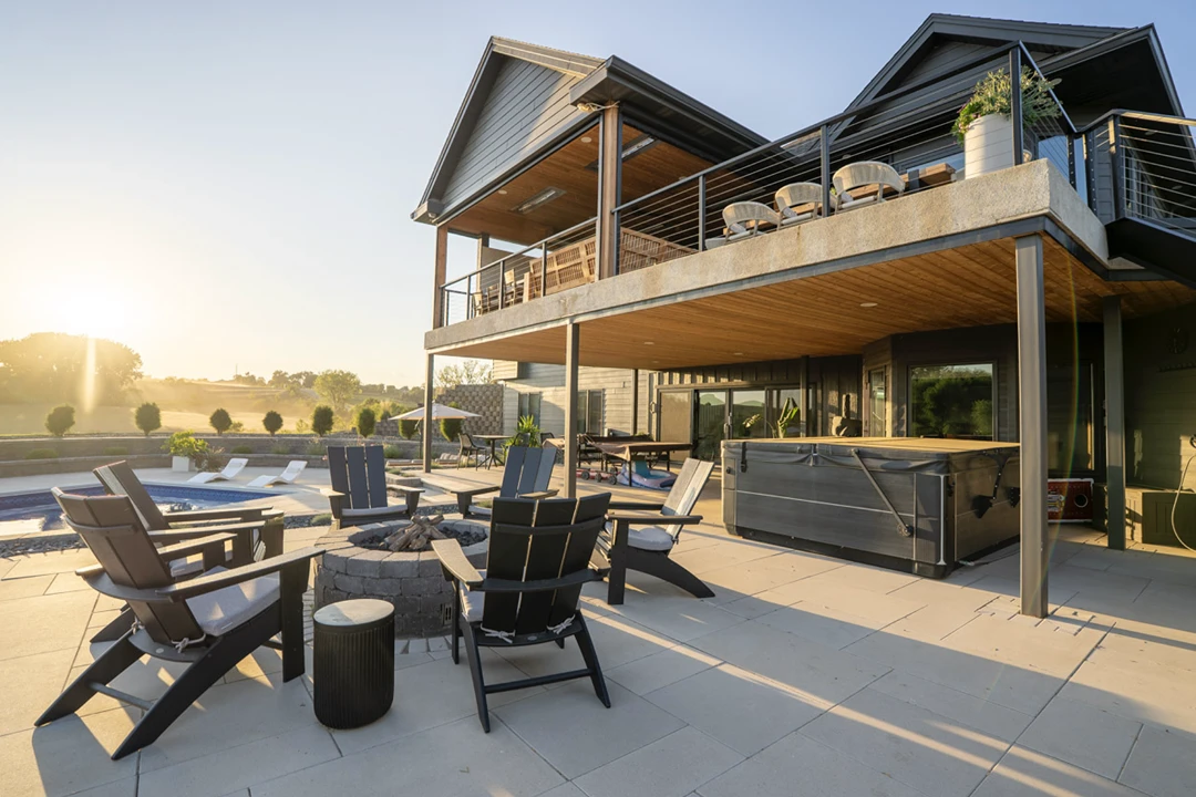 Modern house with patio and sunset view.