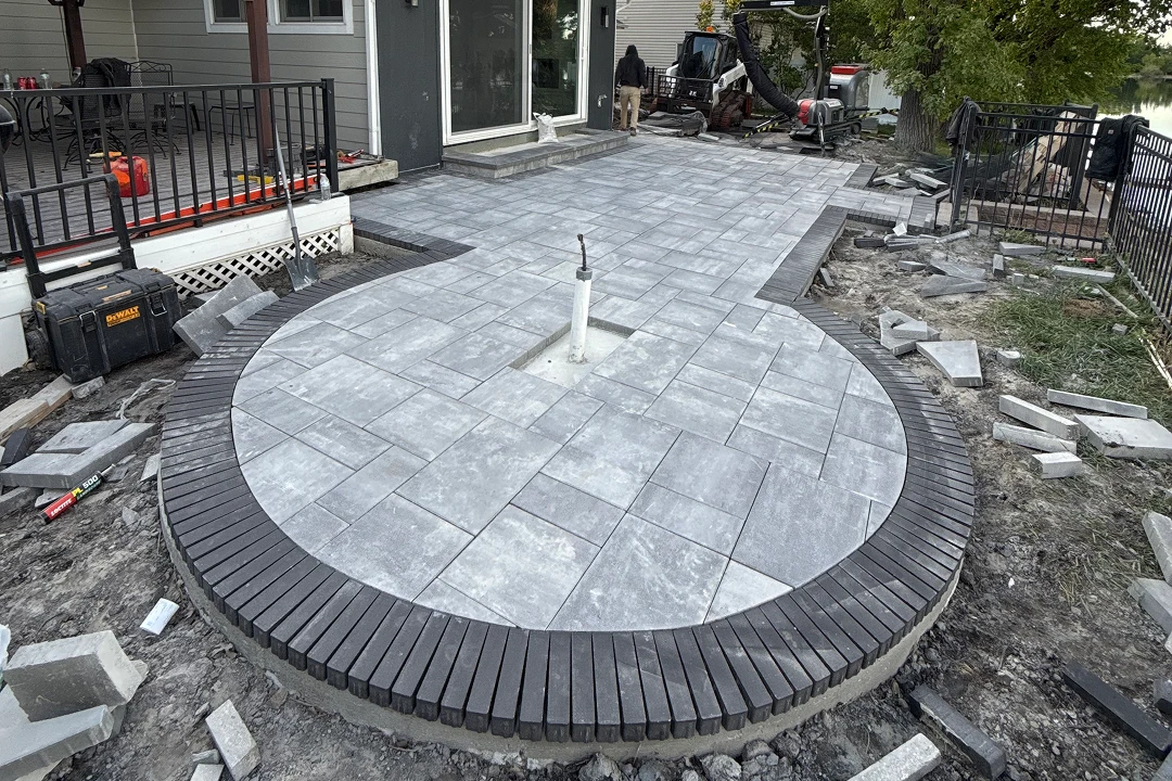Circular patio under construction with pavers.